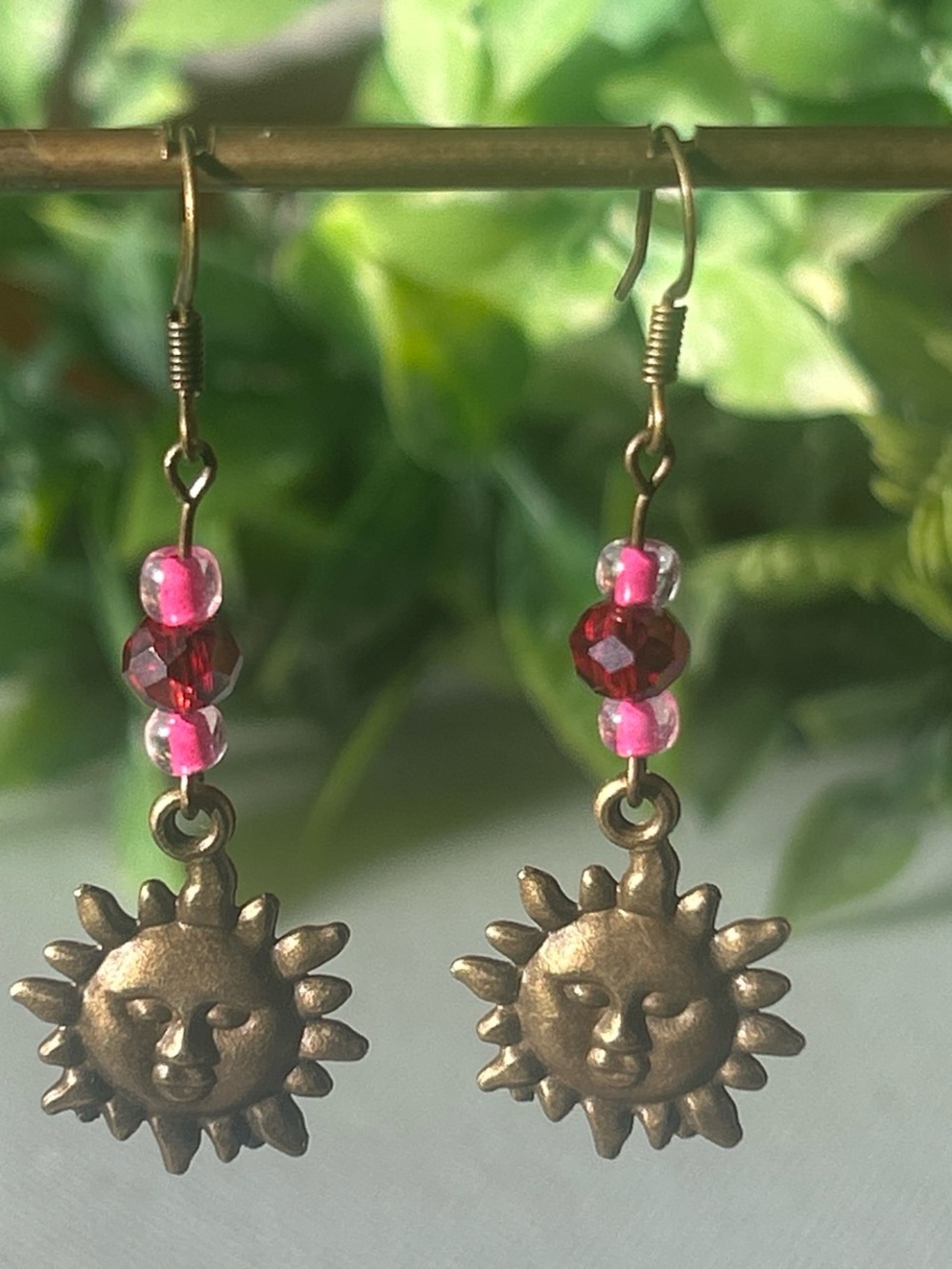 Handmade brass sun earrings with pink beads
